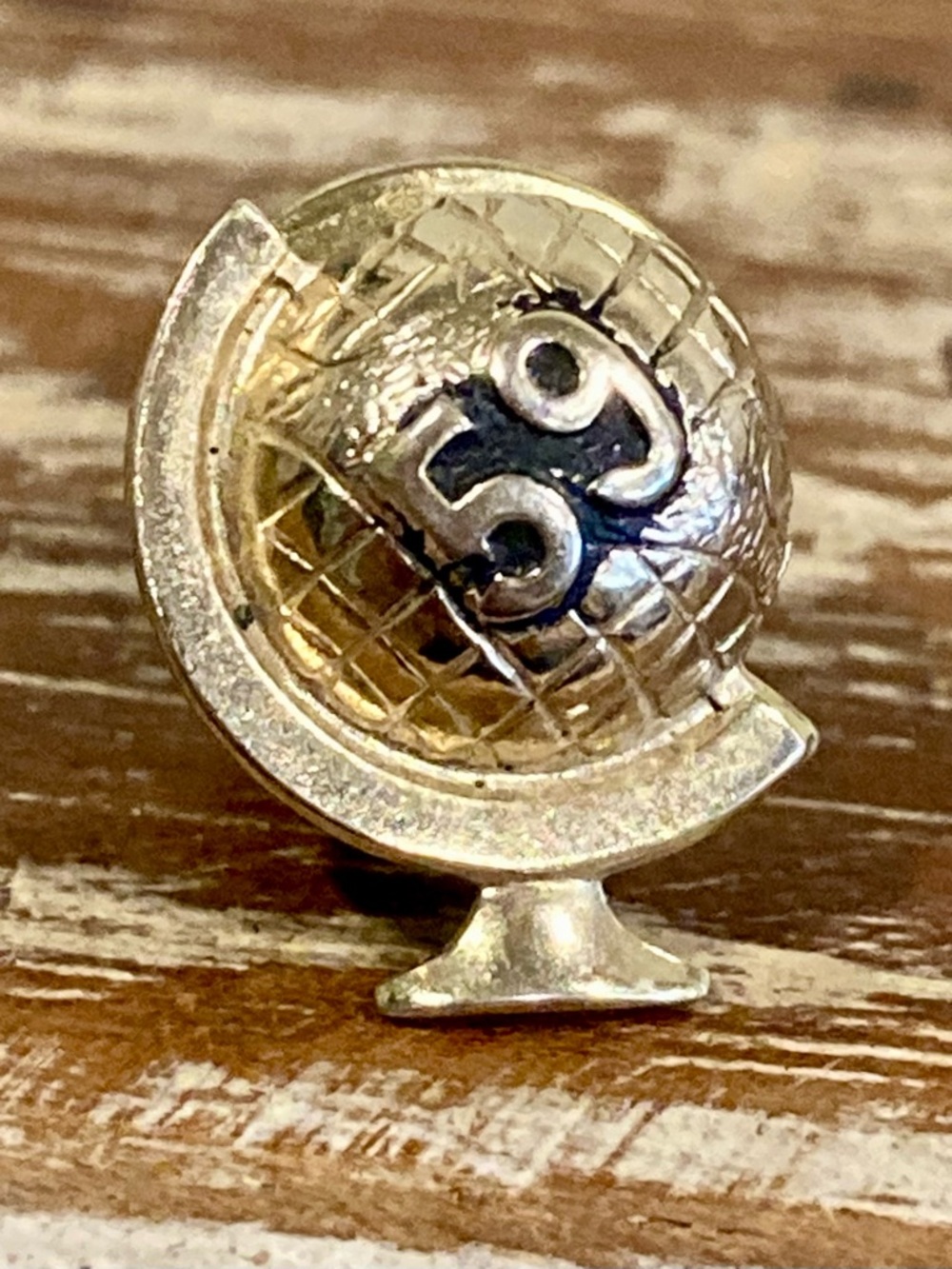 Vintage Gold Tone Globe Lapel Pin with 59 on Black Background